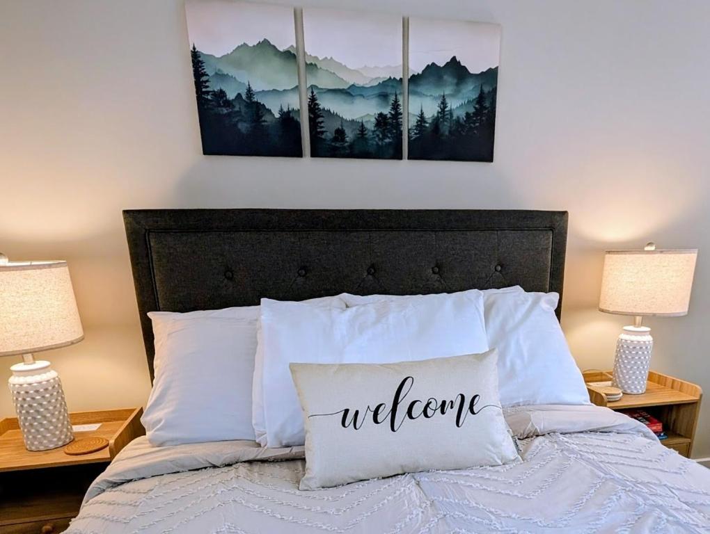 a bedroom with a bed with three paintings on the wall at Ludlow Lax in Ludlow