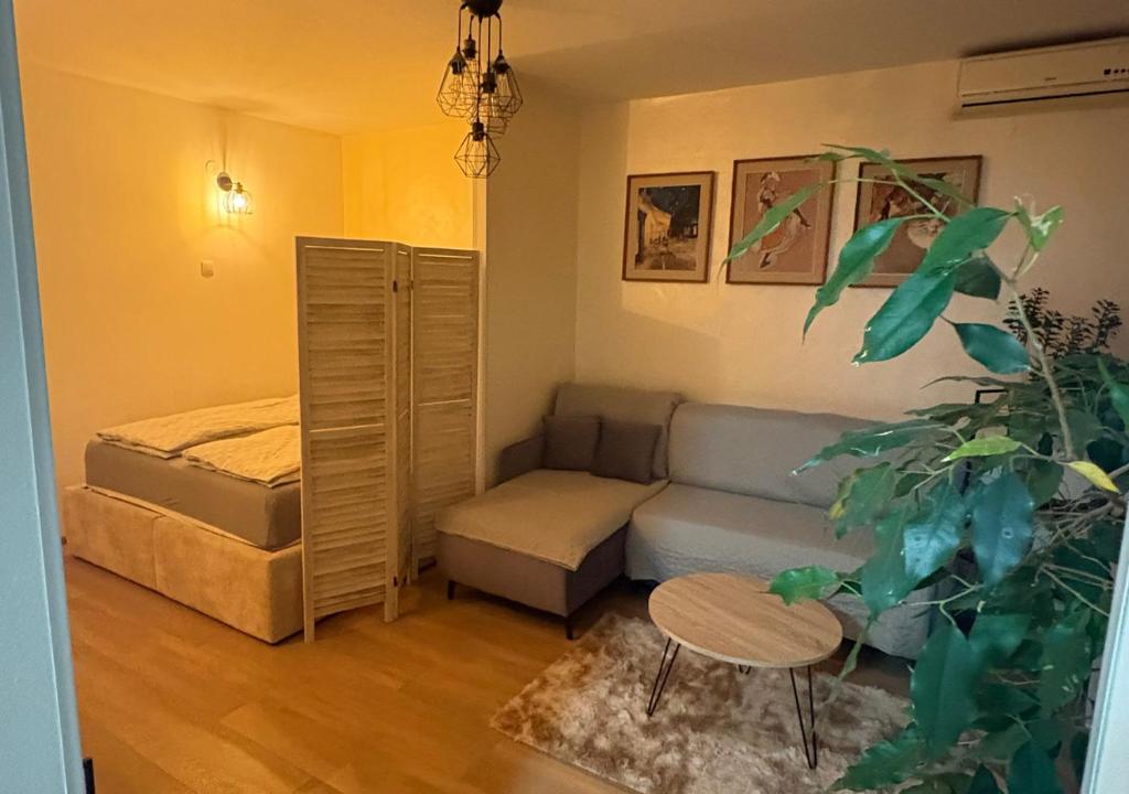 a living room with a couch and a bed at ViLu in Novi Sad