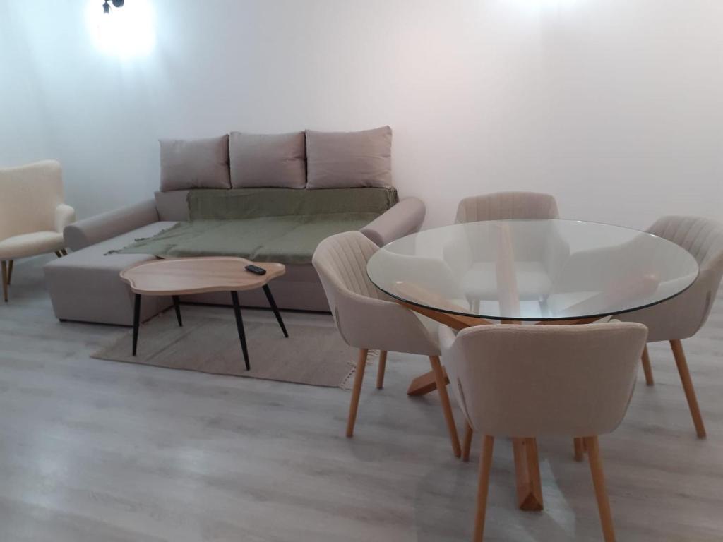 a living room with a couch and a table and chairs at Promenada Mall Apartment4you in Craiova