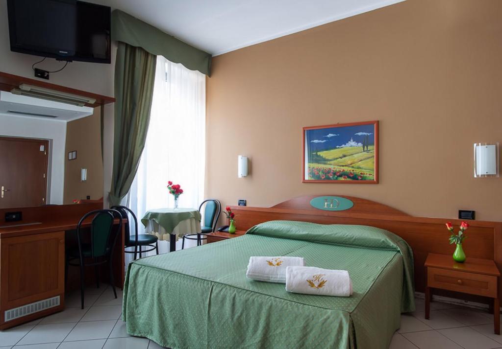 Postel nebo postele na pokoji v ubytování HD Hotel