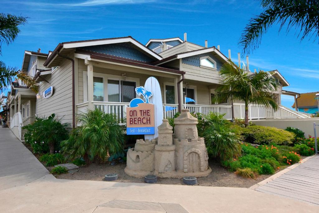 a house with a sign that says on the beach at On the Beach Bed and Breakfast in Cayucos