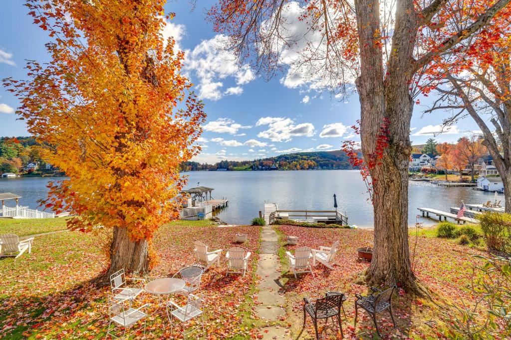 a group of tables and chairs next to a lake at All-Season Getaway on Lake Winola Dock and Sunroom! in Factoryville