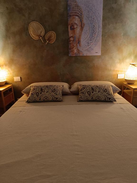 a bedroom with a large bed with two pillows at Pangea - Asia in Trani
