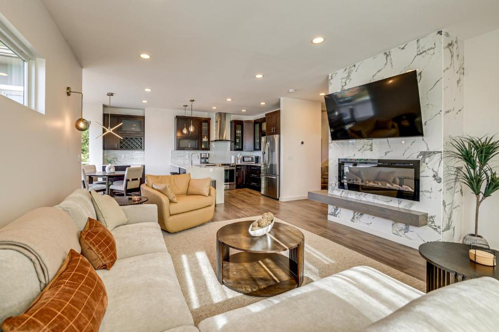 a living room with a couch and a fireplace at 4 Mi to Dtwn Greenville Group-Ready Home with Yard in Piedmont Park