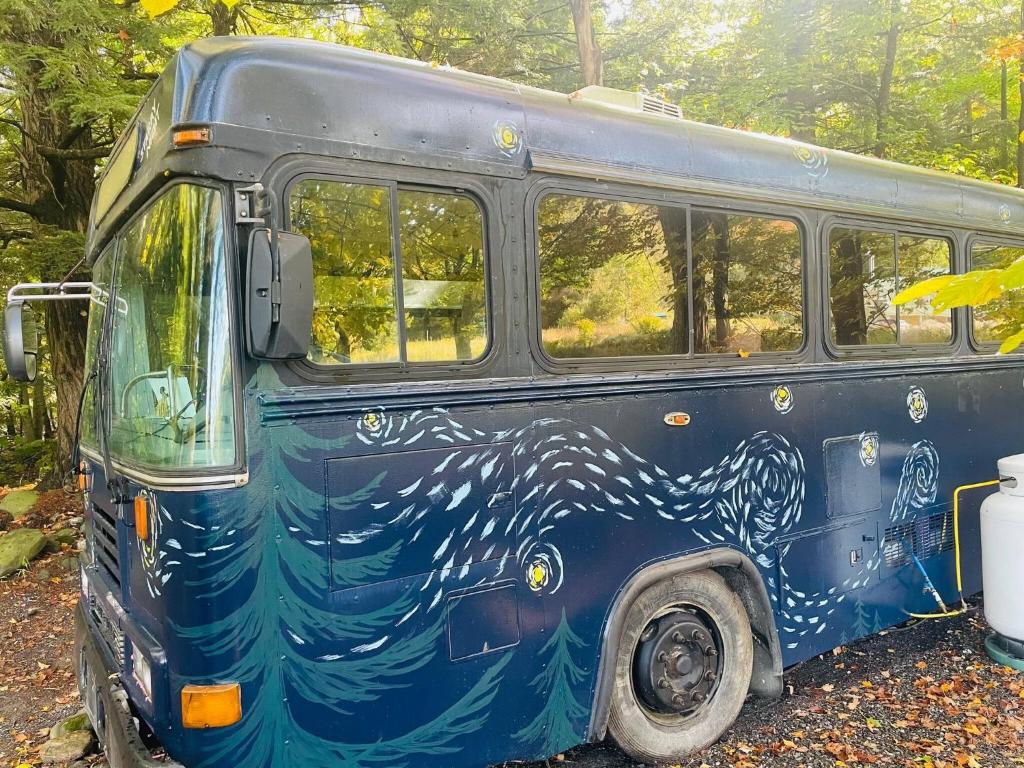 a blue bus with a whale painted on the side at Magic Bus on river w/hot tub at Smuggler's Notch in Morses Mill