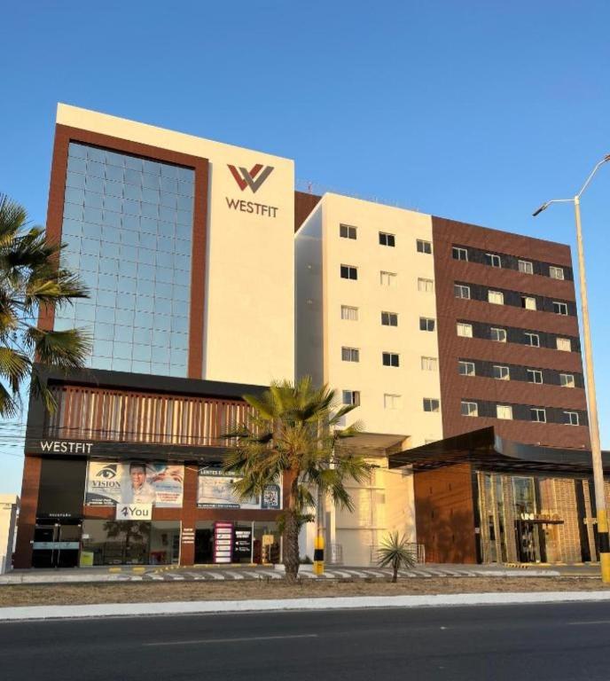 a building with a sign on the side of it at West Fit Padrão 05 in Mossoró
