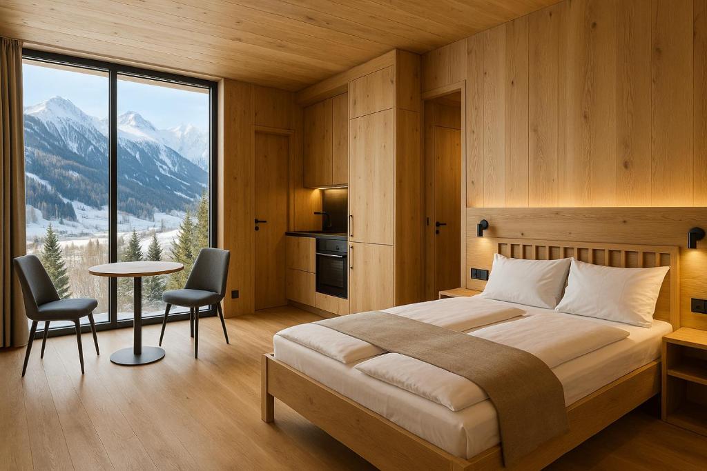 a bedroom with a bed and a large window with mountains at Neues Alpenstudio in Schladming in Rohrmoos