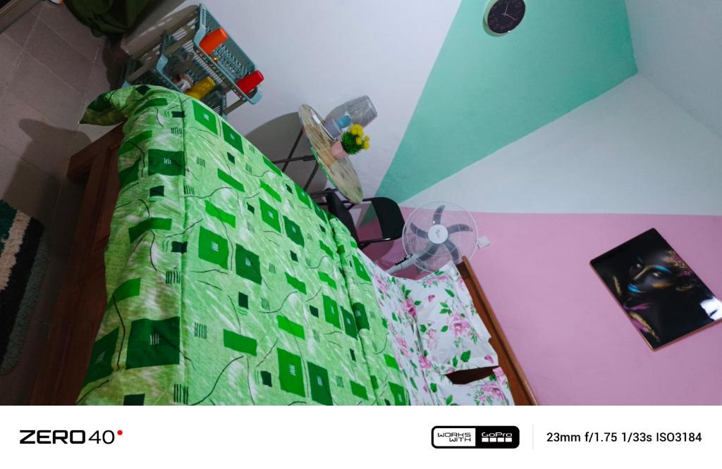 a bedroom with a bed with a lego wall at manoir hoome in Bonabéri