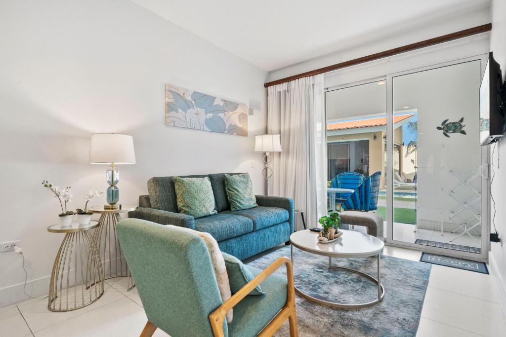 a living room with a couch and a table at Arubas Life 108 in Noord