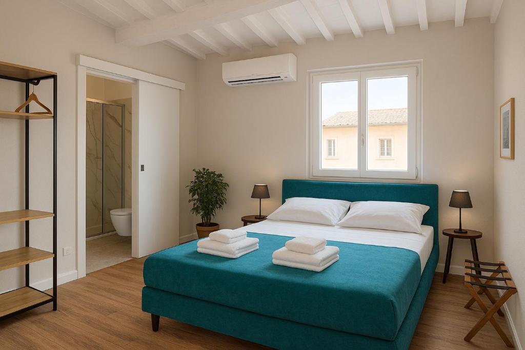 a bedroom with a blue bed with towels on it at NiNNi 12 Apt in Florence