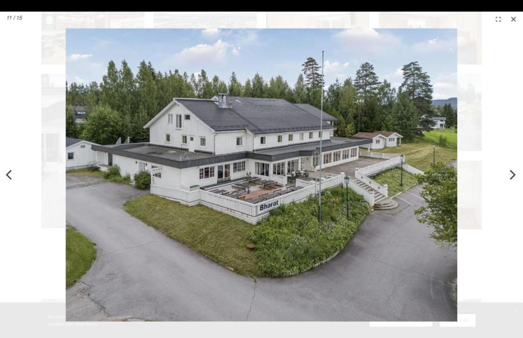 an aerial view of a large white house at Heia Hotell in Våler i Solør
