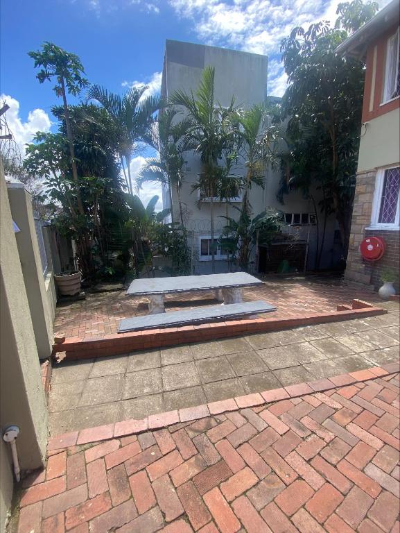 a brick patio in front of a building at Back Packer Style in Durban