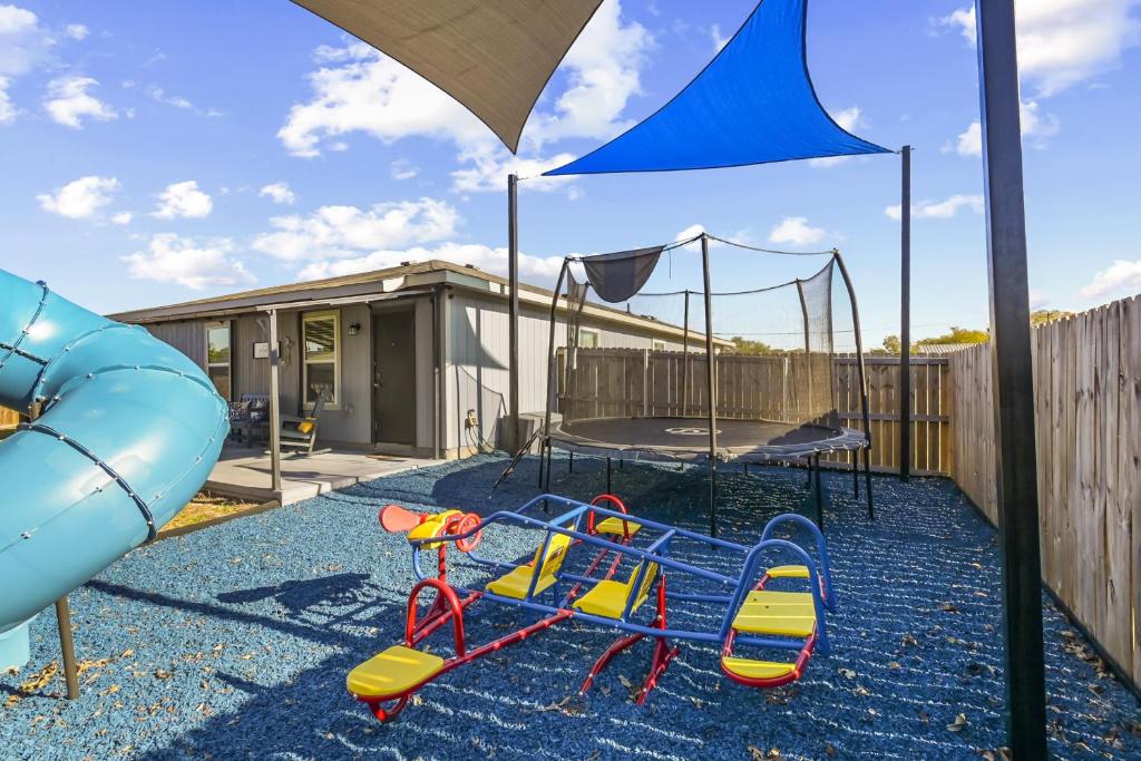 een speeltuin met een glijbaan en een trampoline bij about 6 Mi to Waco Newly Constructed Family Home in Bellmead