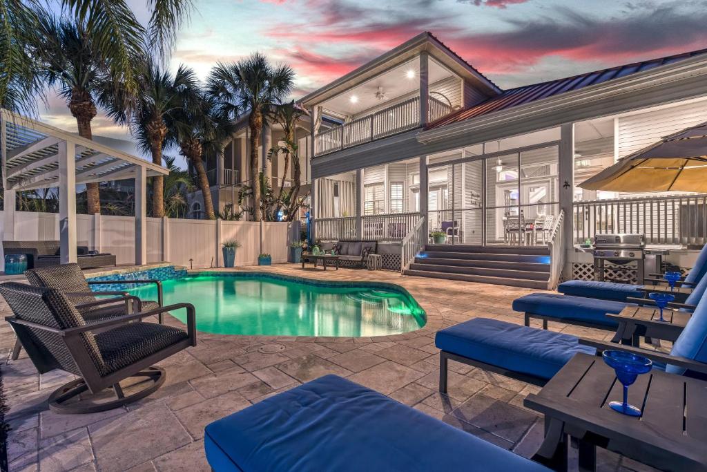 a house with a swimming pool and a patio at Isla Amor - 86 in Siesta Key