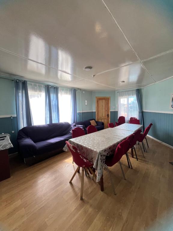 a living room with a table and chairs and a couch at Casas Punta Arenas in Punta Arenas