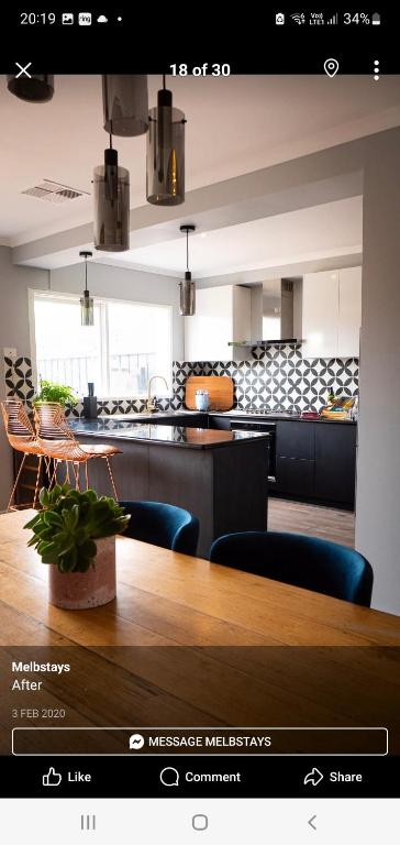 a screenshot of a kitchen with a table and chairs at Fitzroy-private rooms Guest house 4beds 2baths in Melbourne