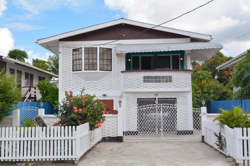 a white house with a white fence at South Oasis in Georgetown
