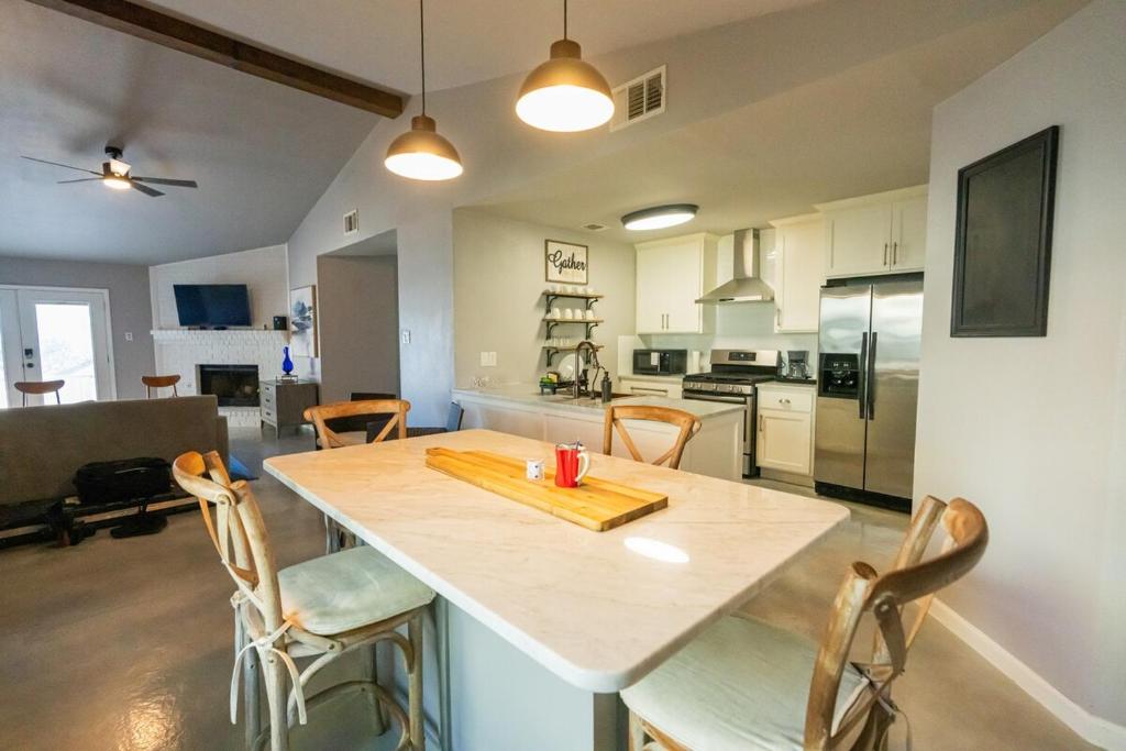a kitchen and living room with a table and chairs at 5 minute walk to the gulf course in San Antonio