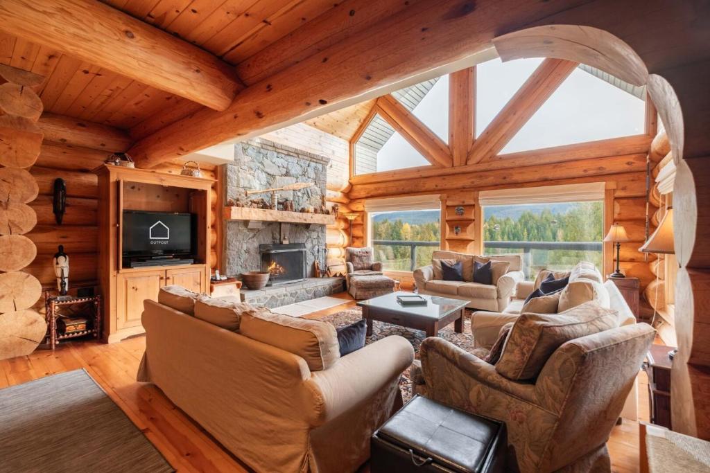 a living room with a large vaulted ceiling at Heron Chalet by Outpost Whistler in Whistler