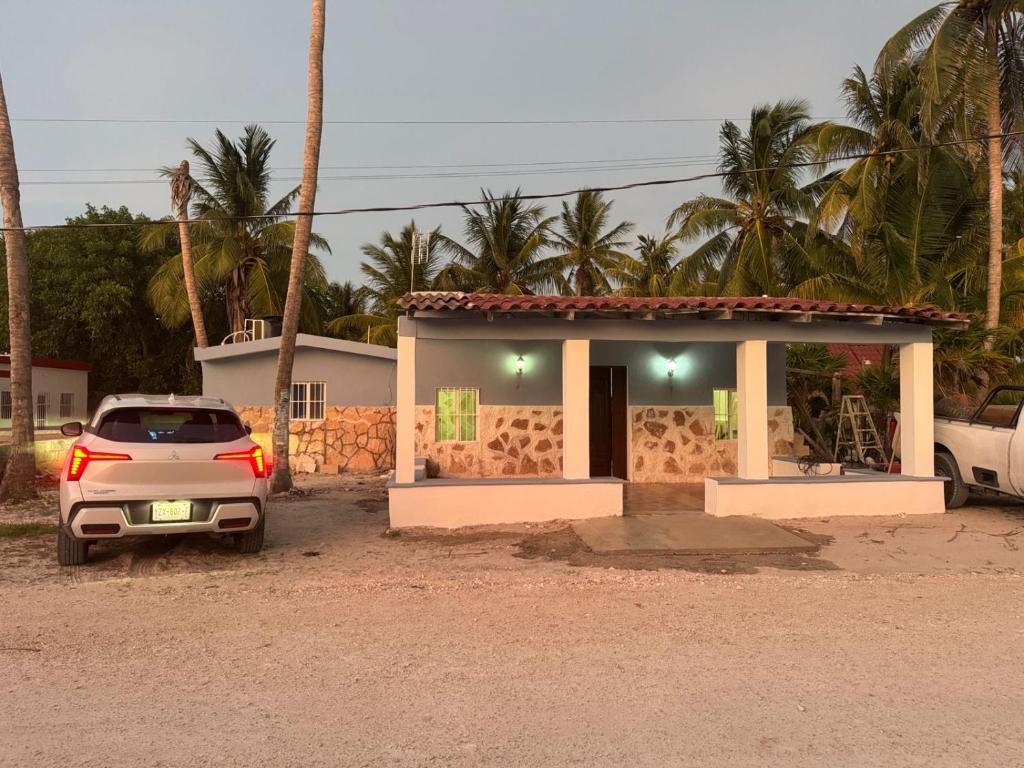 a car parked in front of a small house at Casa Tortuga in Chelem