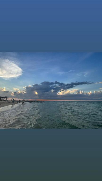 a group of people walking on the beach at Casa Tortuga in Chelem