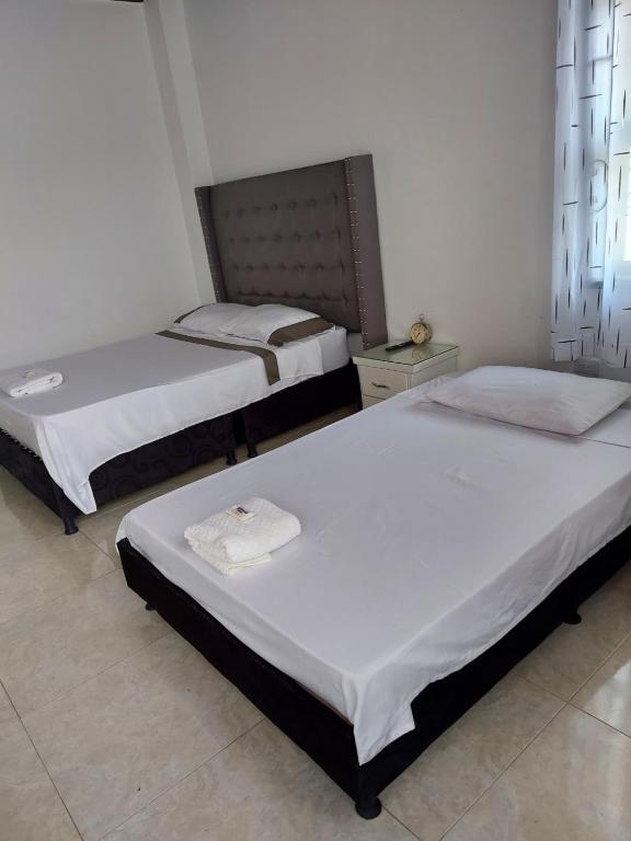 two beds sitting in a room with at Casa Bella in Rivera