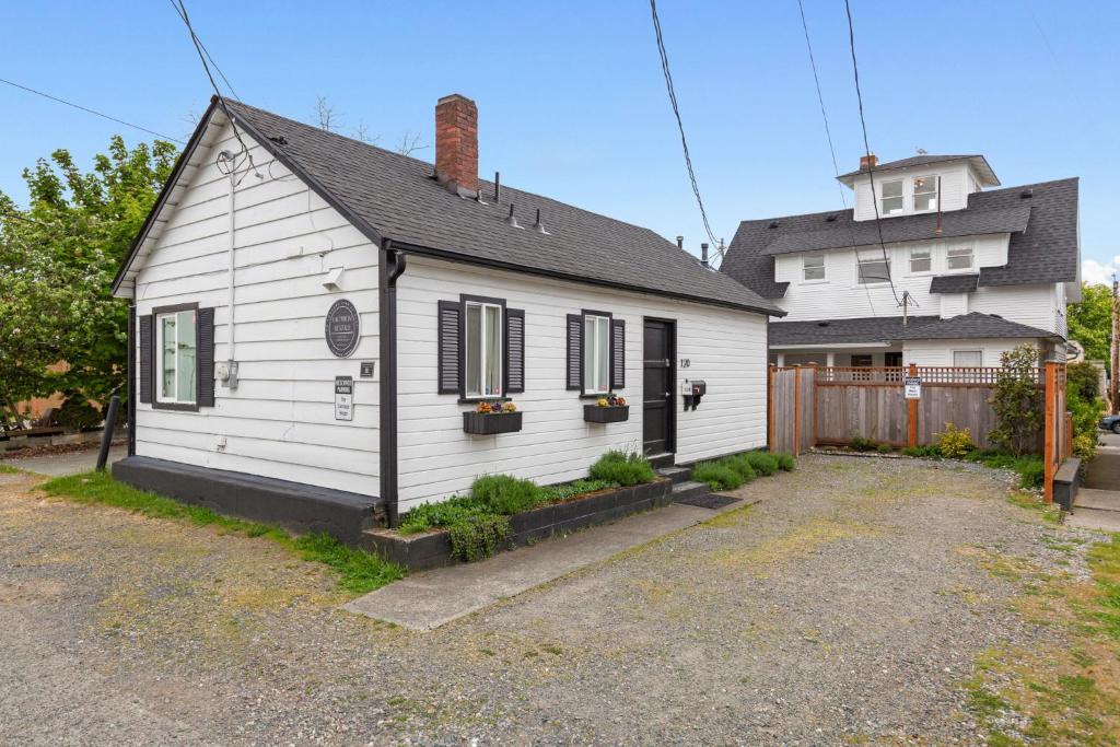 a white house with black shutters on a house at Downtown location Near the Beach Dog Friendly in Edmonds