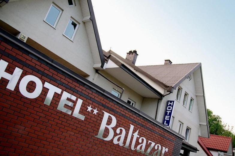 a hotelption sign on the side of a building at Hotel Baltazar Pułtusk in Pultusk