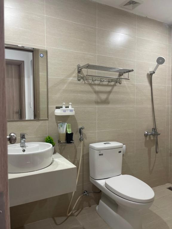 a bathroom with a white toilet and a sink at Beer Homestay Nera Garden Hue in Hue