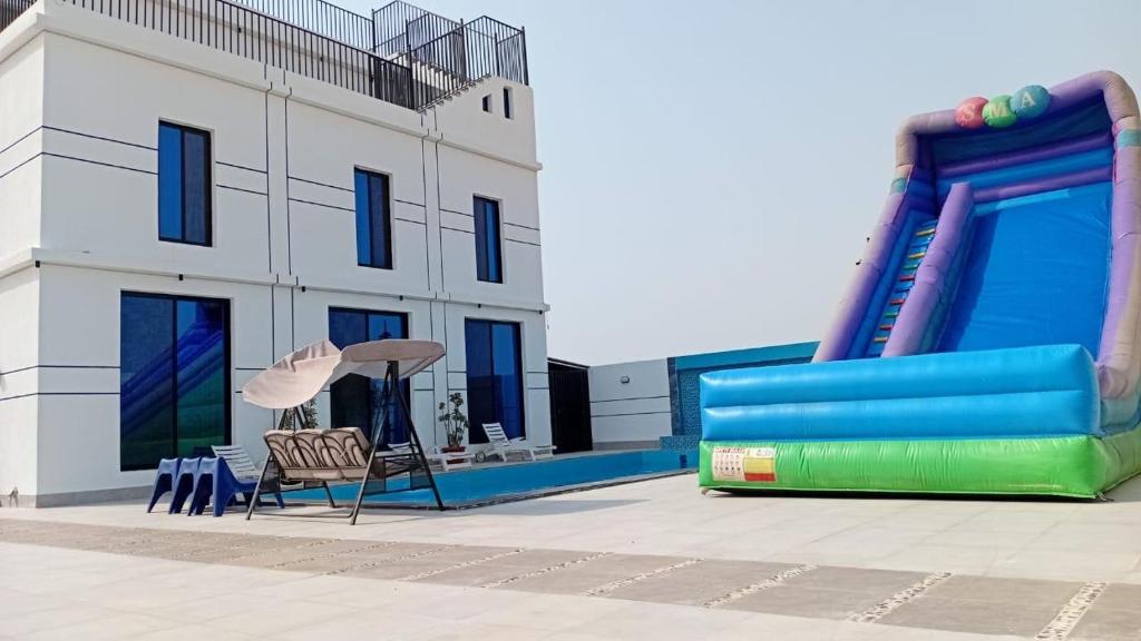 a building with a slide and a chair in front of it at aroya in Jeddah