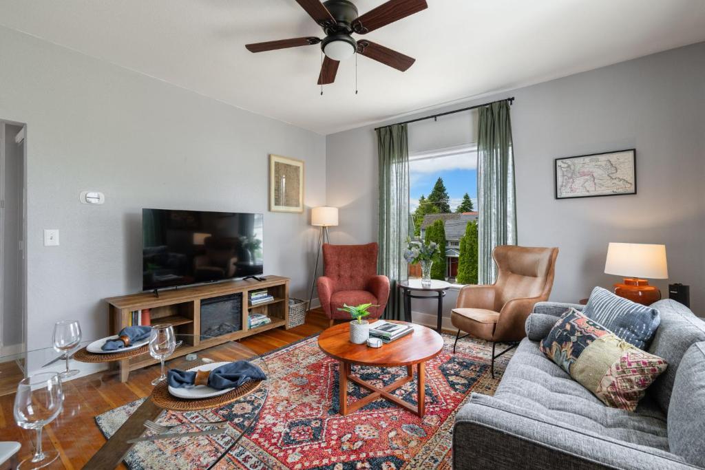 a living room with a couch and a tv at King Bed, Near DT and Best Restaurants, Pets OK! in Tacoma