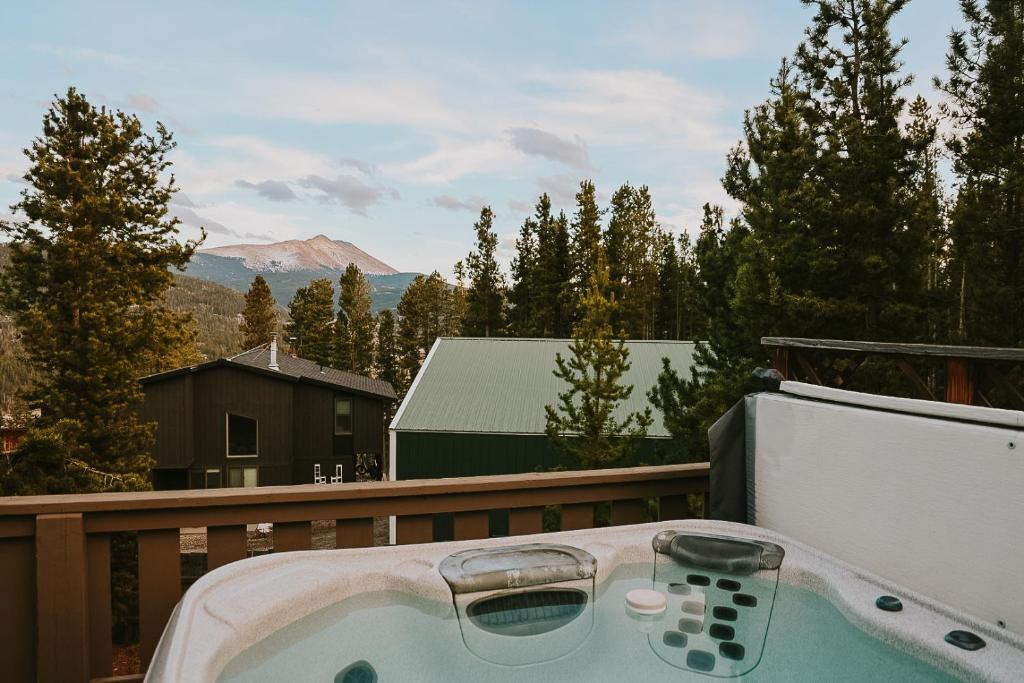 a bath tub sitting on a deck with aperature at Breck Ski Chalet, Pet Friendly, Private Hot Tub and Scenic Views in Breckenridge
