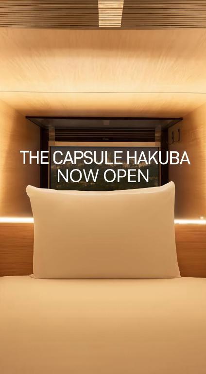 a sign that says the capsule hacienda now open at The Capsule Hakuba in Hakuba