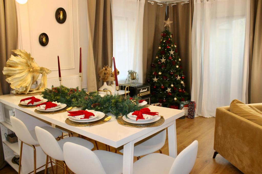 a living room with a christmas tree and a table at Suite de Luxe à 10 min de Paris - Sauna, Cinéma in Bagneux