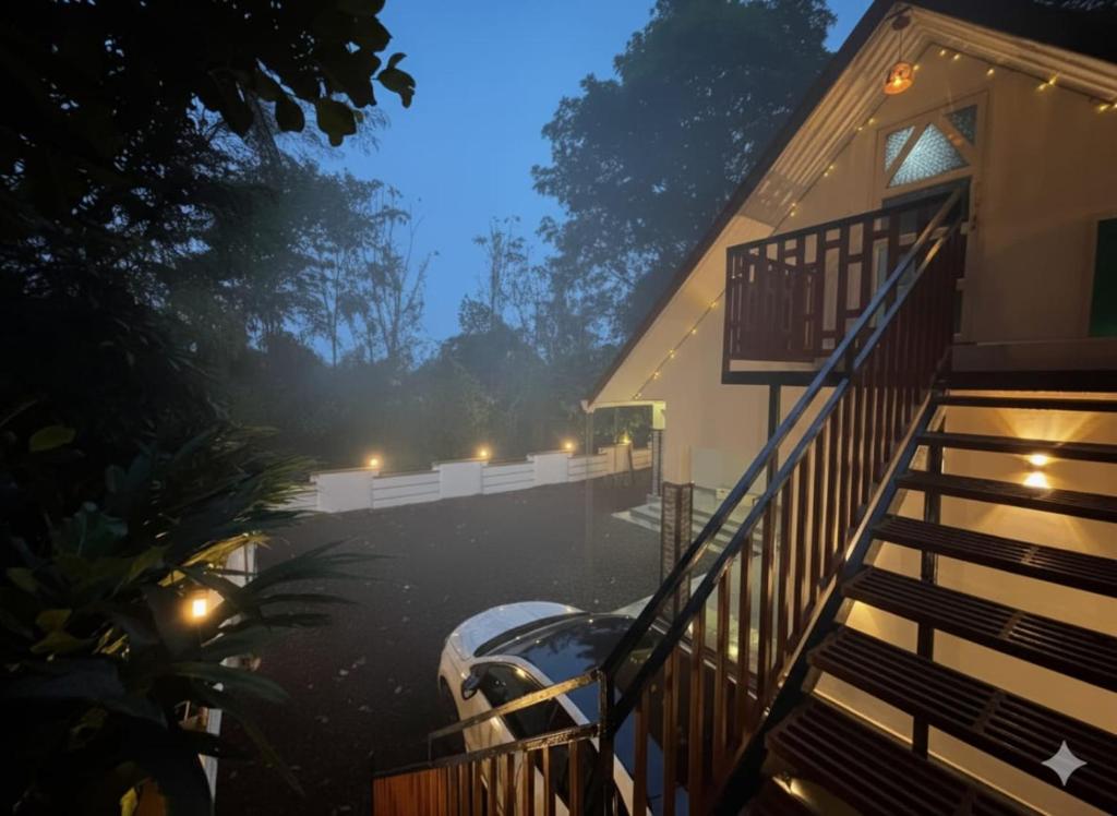 a house with a car parked outside of it at Cloud Hills Munnar in Kallar Vattiyar