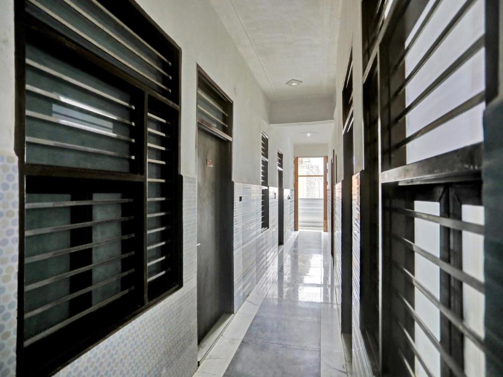 a hallway with black and white tiled walls at Hotel O Hotel Valentine's in Rohtak