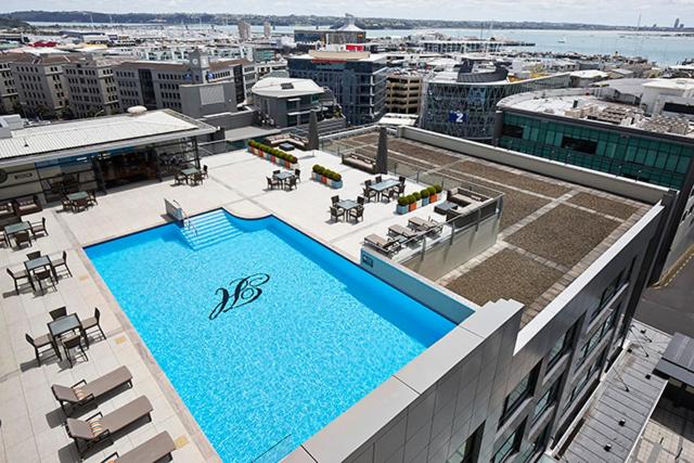 a large swimming pool on top of a building at Heritage Auckland, A Heritage Hotel in Auckland