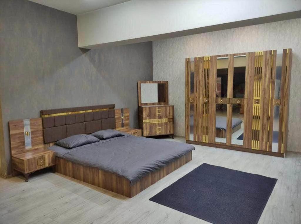 a bedroom with a large bed and a mirror at إقامة classi in Nouakchott
