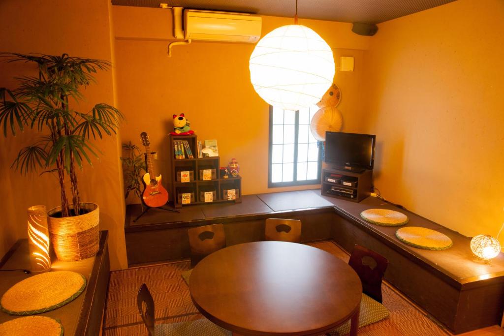 a dining room with a table and a window at K's House Tokyo Oasis - Quality Hostel in Asakusa in Tokyo