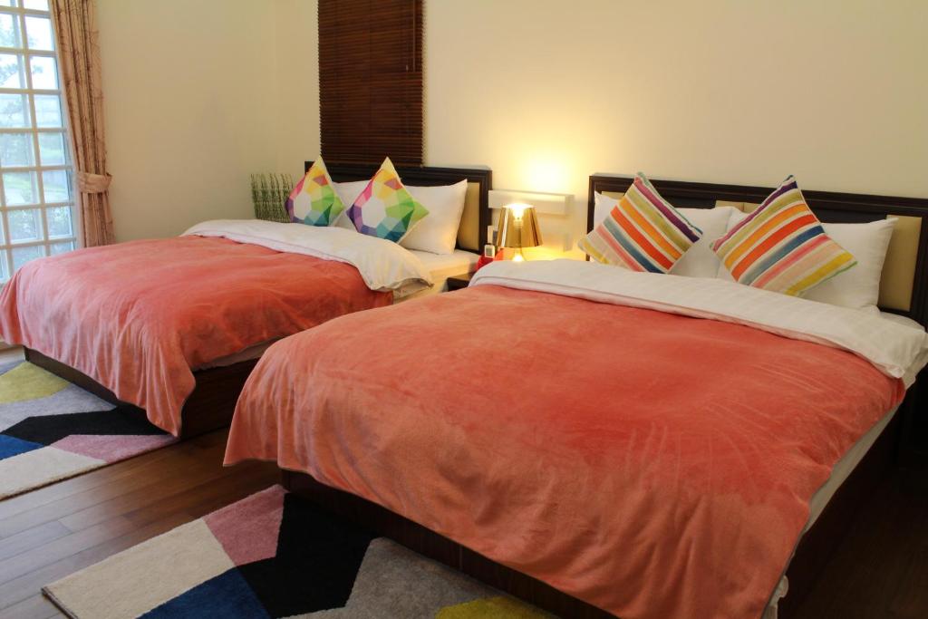 Postel nebo postele na pokoji v ubytování Yilan Amy B&B