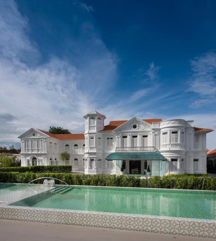 a large white mansion with a swimming pool at Macalister Mansion, a Member of Design Hotels in George Town