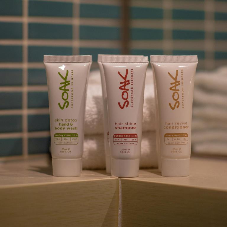 a group of three bottles of sunscreen on a shelf at Best Western Melbourne City in Melbourne