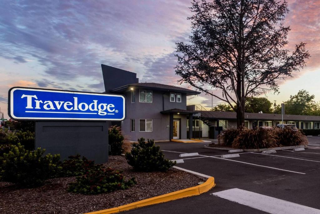 a sign in a parking lot in front of a hotel at Travelodge by Wyndham Santa Rosa Wine Country in Santa Rosa