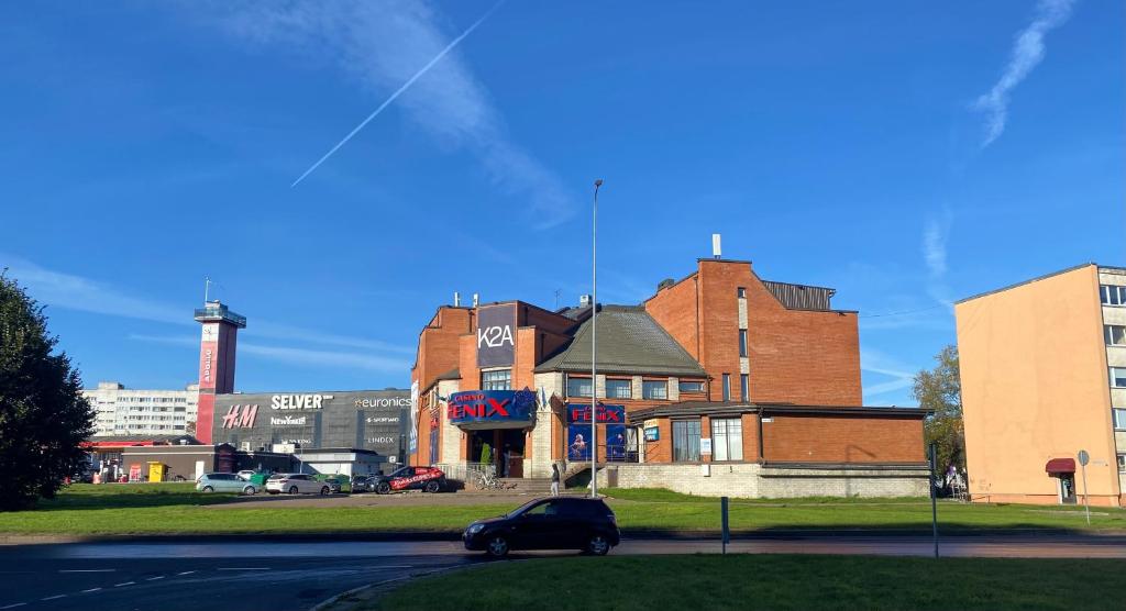 a car parked in front of a brick building at Narva Kangelaste 2 Apartments in Narva