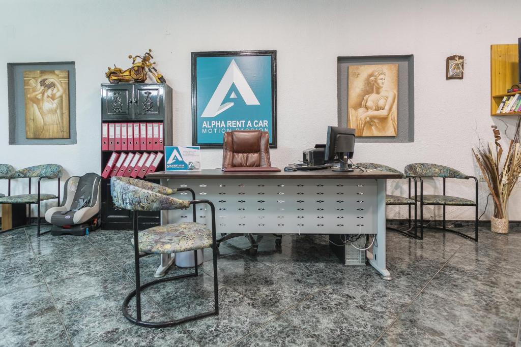 an office with a desk and chairs in a room at Alpha Studios in Arkasa