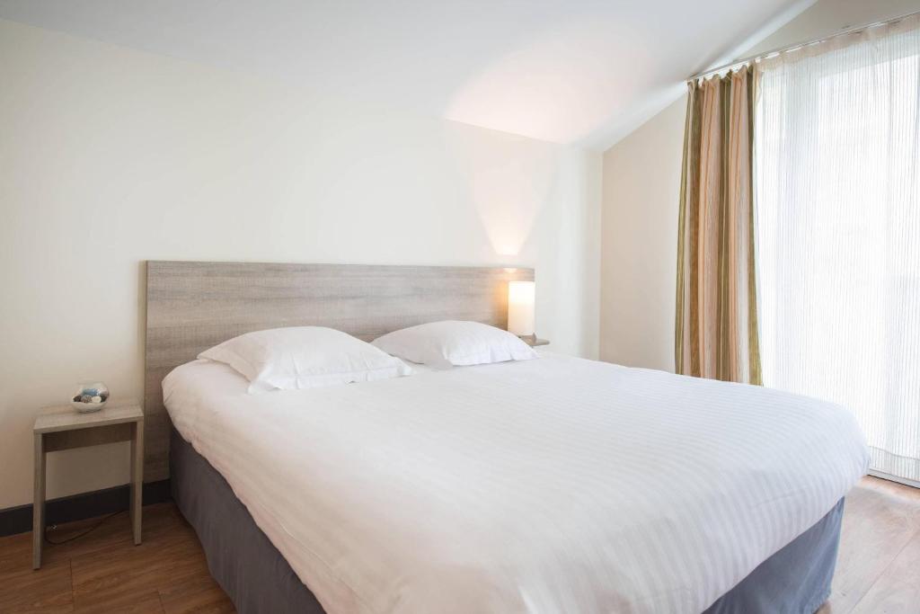 Postel nebo postele na pokoji v ubytování Comfort Aparthotel Saint-Nazaire Les Portes de l Ocean