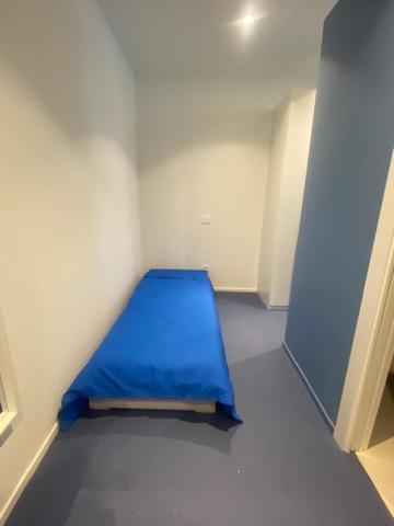 a small room with a blue bed in it at Mediterranea in Arenzano