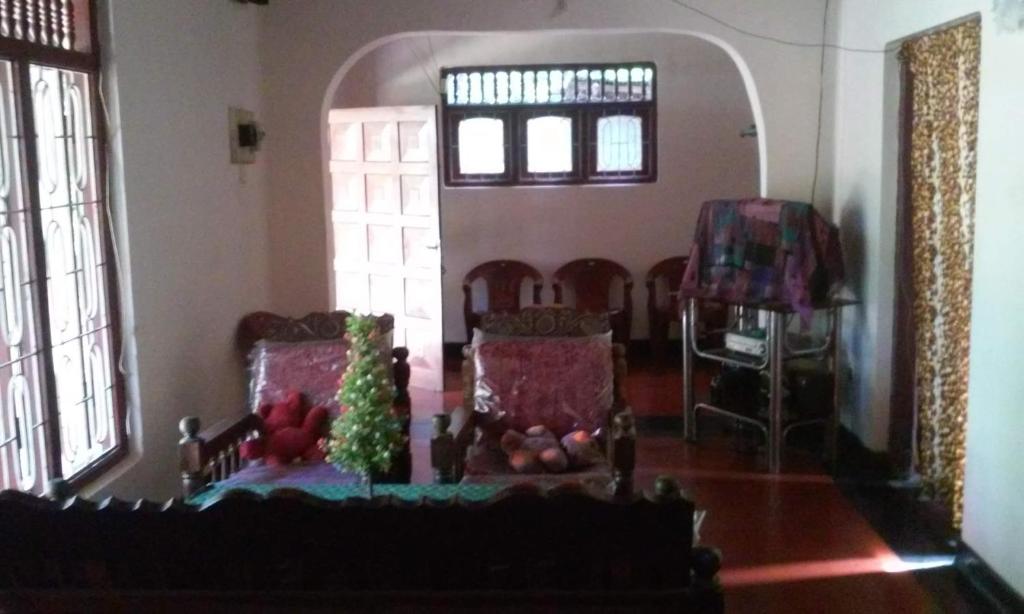 a living room with two chairs and a table at Vilage Home in Polonnaruwa