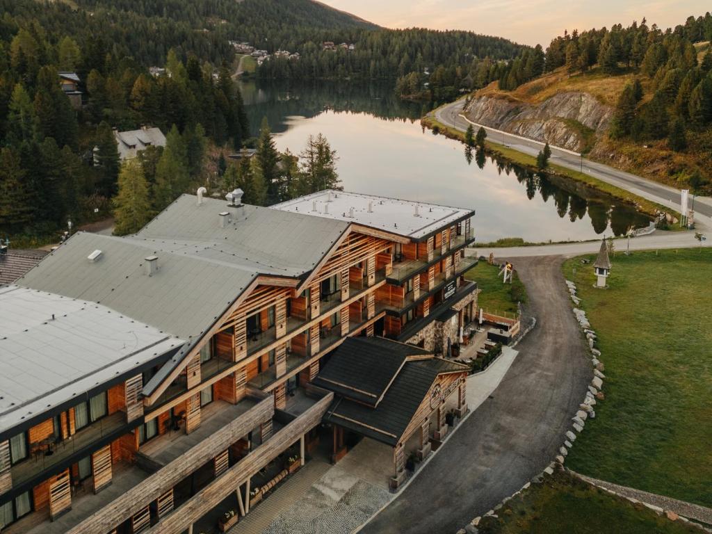 an aerial view of a building next to a river at Alpin Peaks in Turracher Hohe