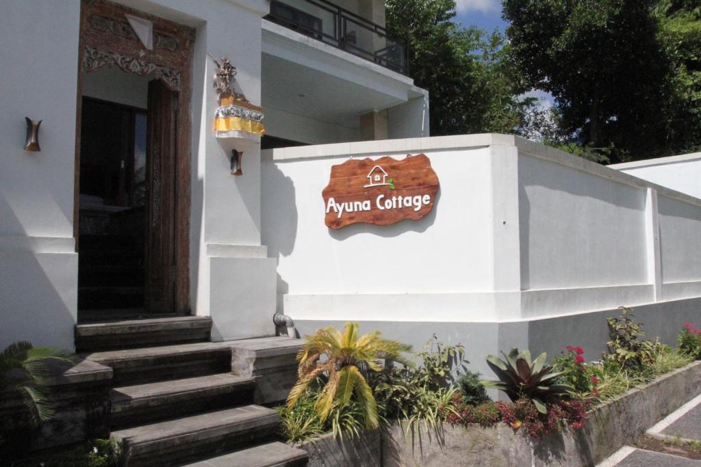 a sign on the side of a building at Ayuna Cottages in Bedahulu